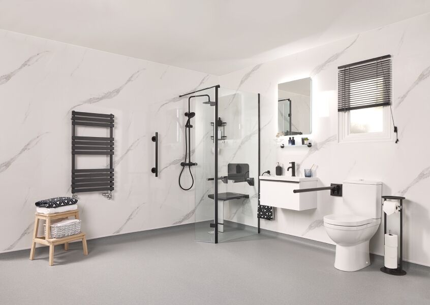 Modern accessible bathroom with a level access shower, grab rails and a wall-hung basin