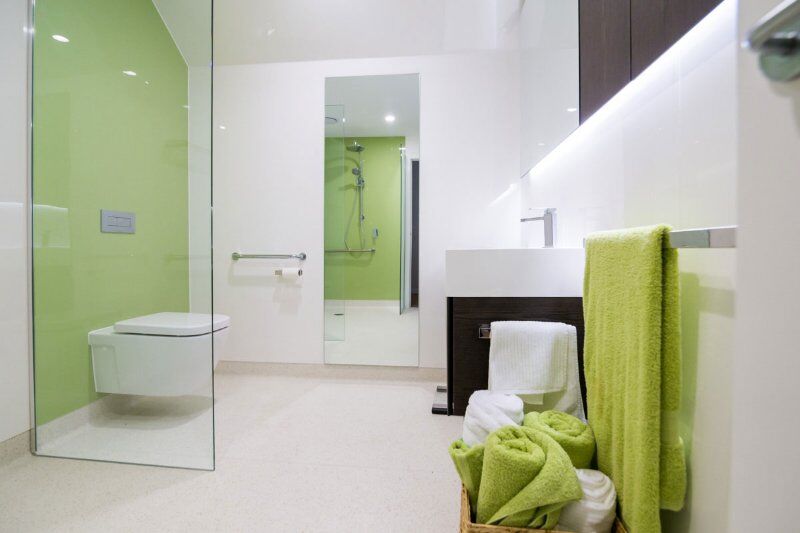 Small space accessible wet room design with wall hung toilet and floating basin