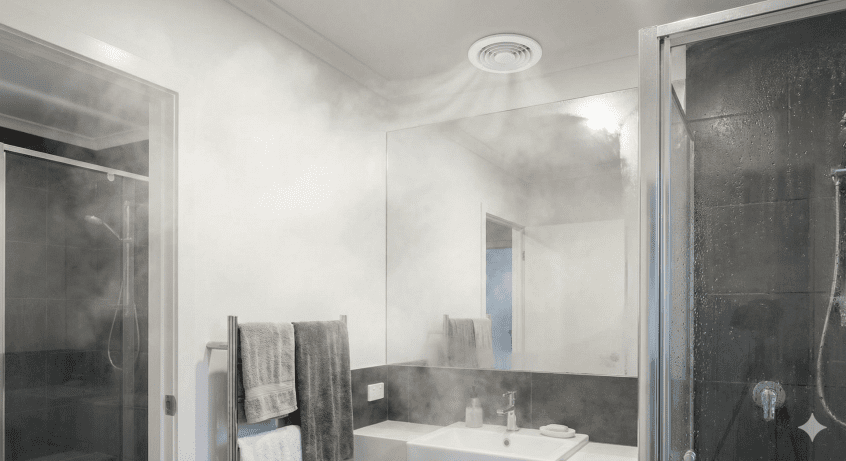 Discreet circular inline extractor fan vent on a bathroom ceiling to remove steam quickly and prevent mould.