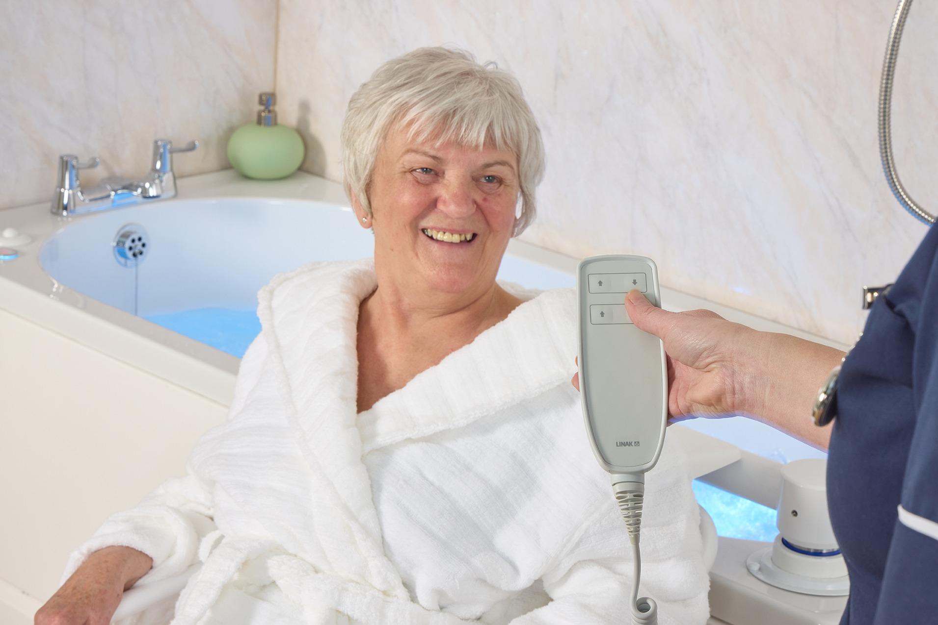 Assisted bath with transfer seat and adjustable height, installed by EA Mobility