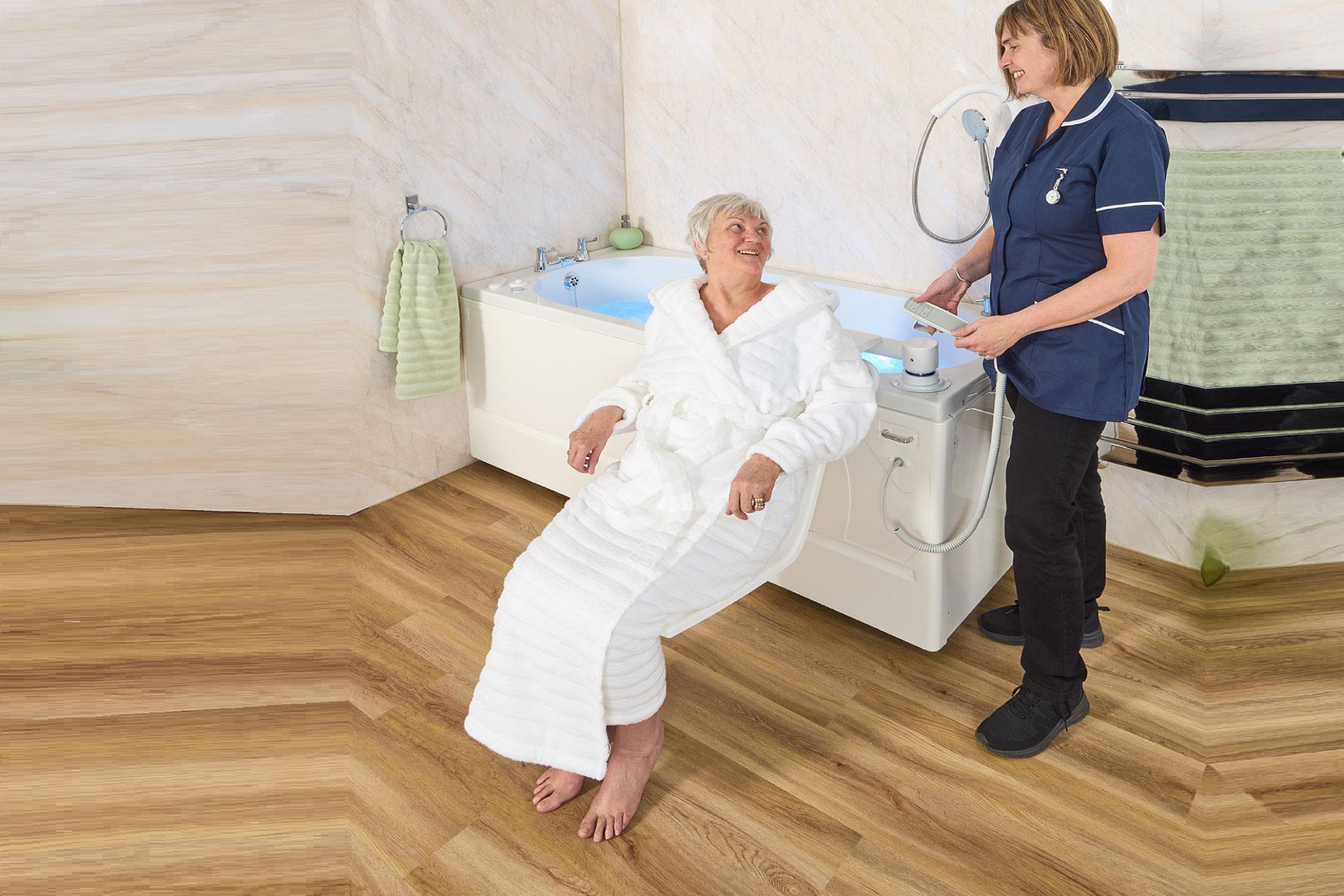 Bath lift lowering into a bath, from EA Mobility
