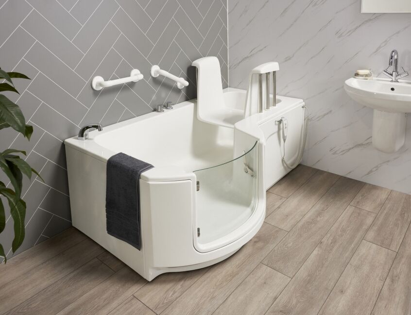 Powered bath lift chair inside a bath, showing the height it raises the user from the bath floor