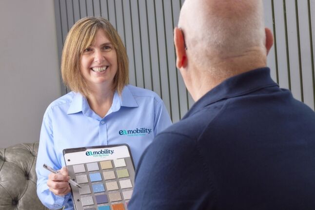 An EA Mobility advisor showing colour samples to a client