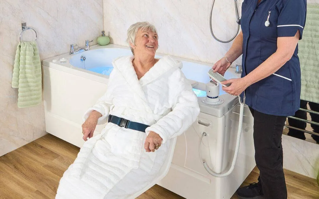 Carer helping a woman use a walk-in bath with a powered bath lift