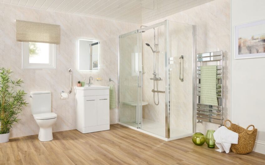 Fully adapted elderly bathroom featuring walk-in shower with seat, safety rails, and warm modern design
