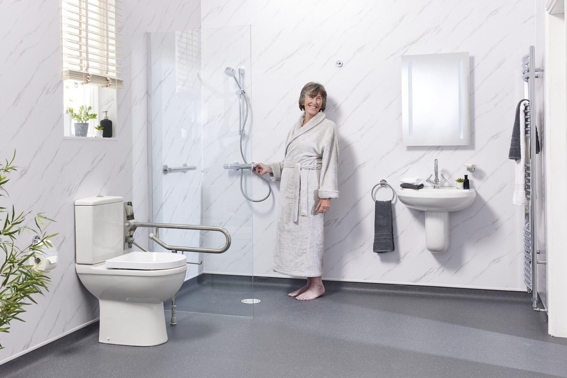 Spotless modern disabled wet room with clean glass screen and safety flooring