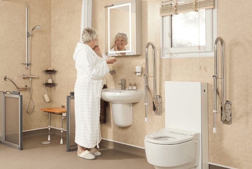 Compact disabled wet room with wall-hung basin and fold-down shower seat