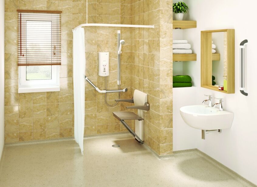 Accessible wet room with fold-down shower seat, grab rails, level shower area and wall-mounted basin