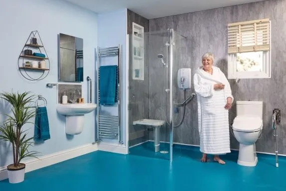 Accessible wet room with walk-in shower, grab rails and level-access flooring by EA Mobility