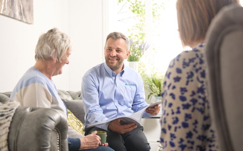 EA Mobility home assessor talking through bathroom options with an older couple at home
