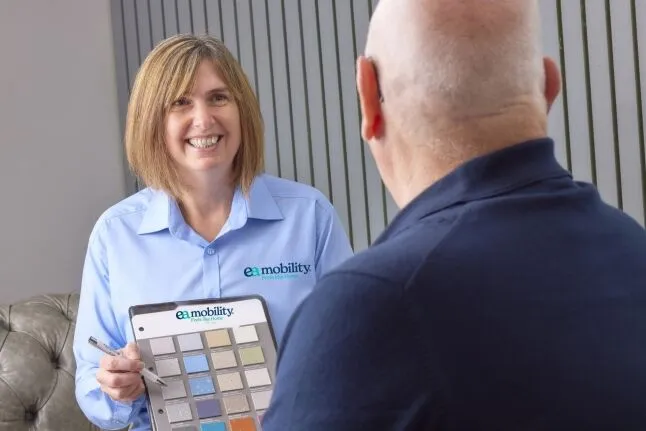 An EA Mobility advisor showing colour samples to a client