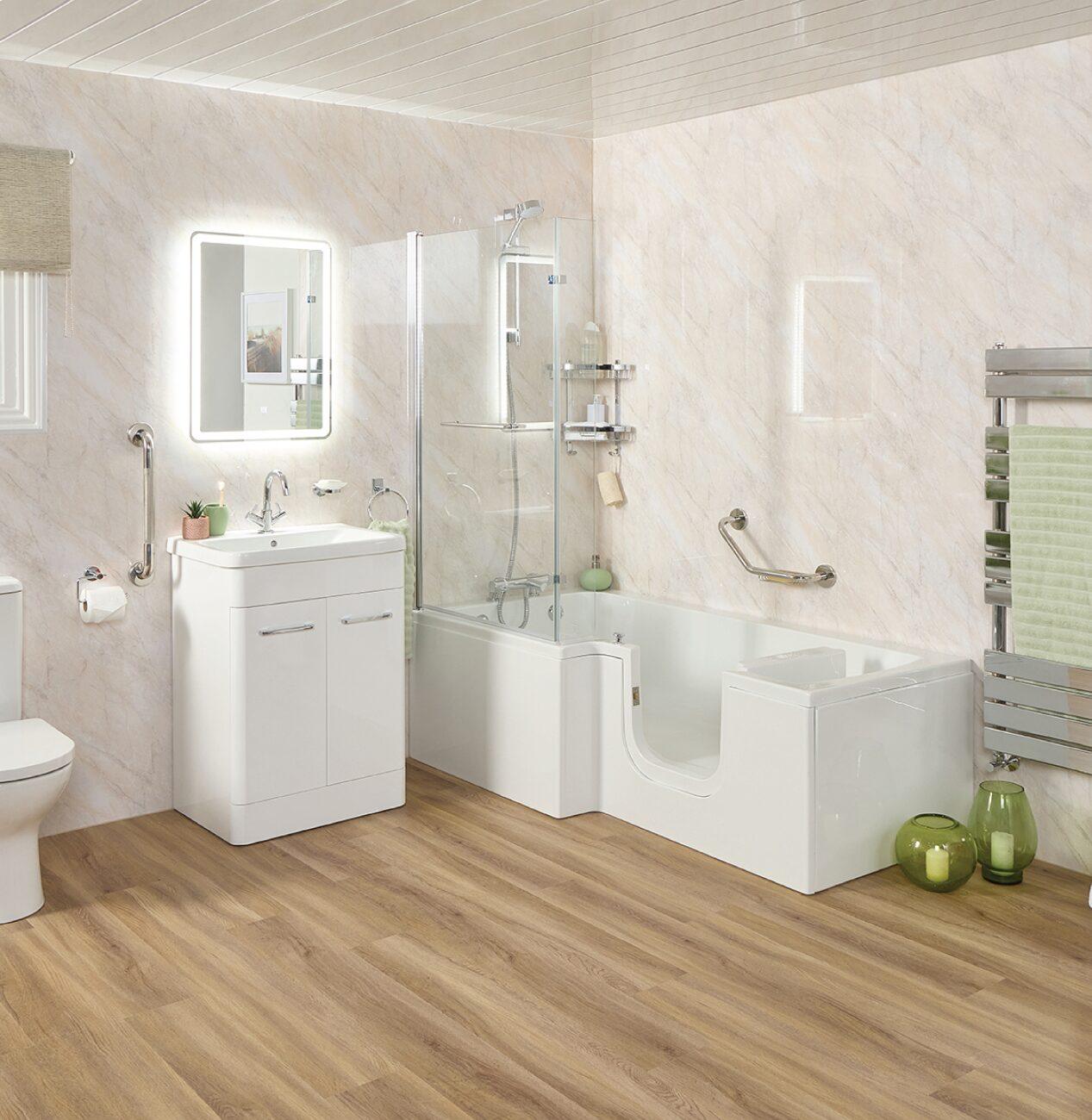 Modern accessible bathroom with a walk-in bath, glass shower screen, vanity unit, and safety grab rails.