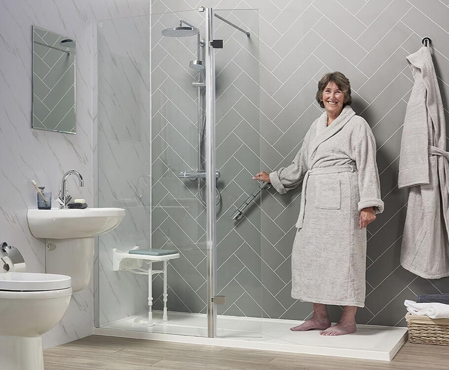 A spacious, modern wet room with level access, slip-resistant flooring, and integrated safety features like grab rails and a shower seat.