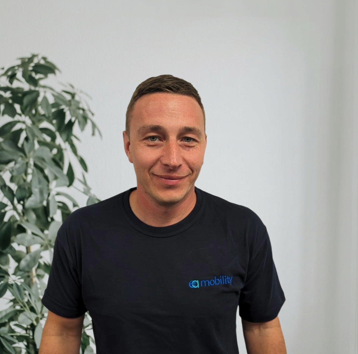 EA Mobility team member wearing light blue shirt in professional headshot