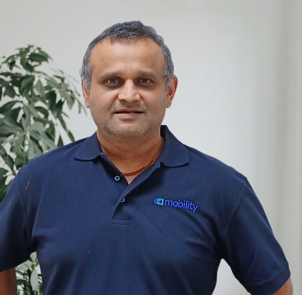 EA Mobility team member wearing light blue shirt in professional headshot