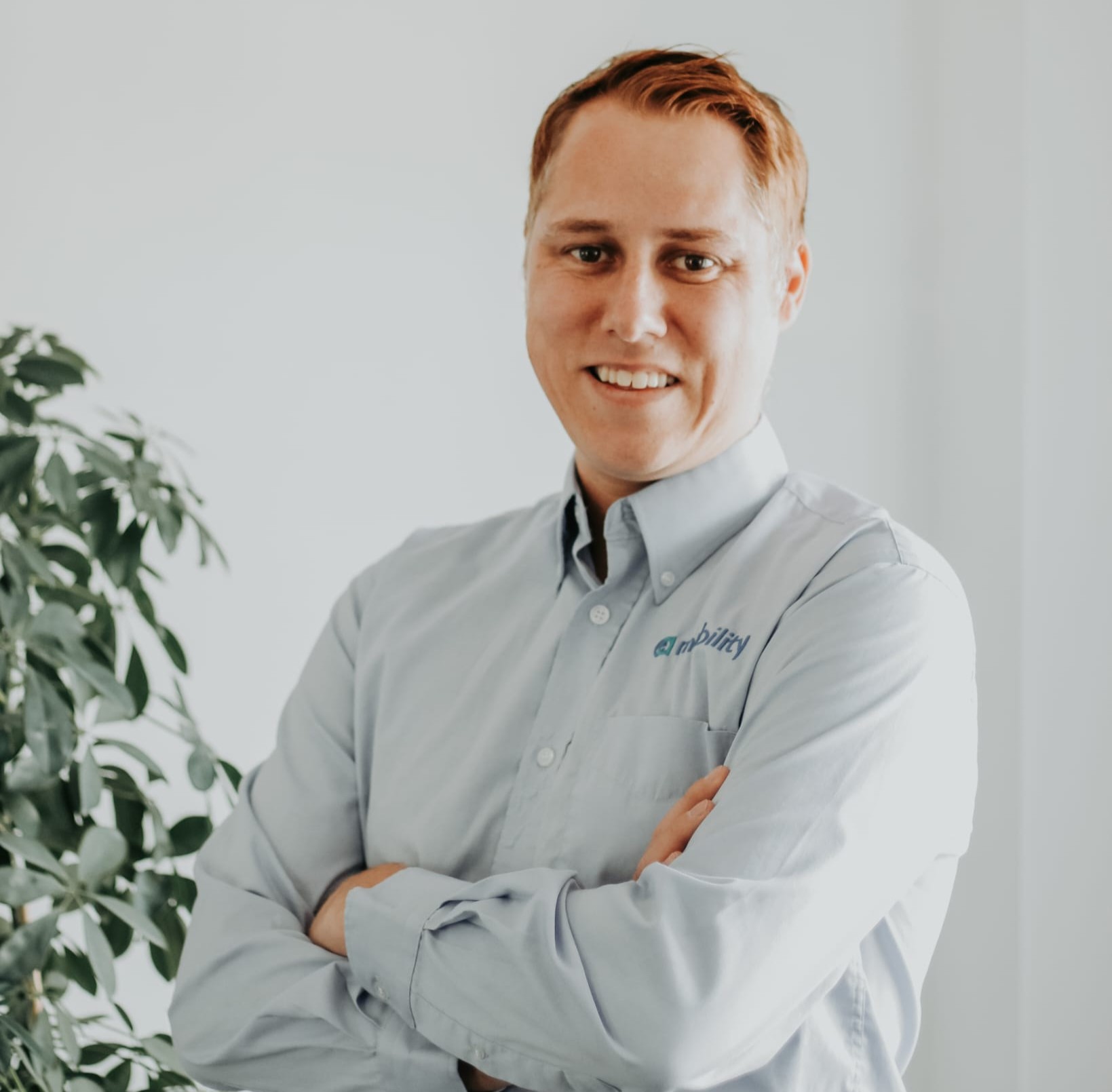 EA Mobility team member wearing light blue shirt in professional headshot